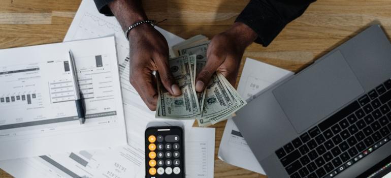 Why Moving Belongs in Your Household Risk Management Plan a man counting money and making plans